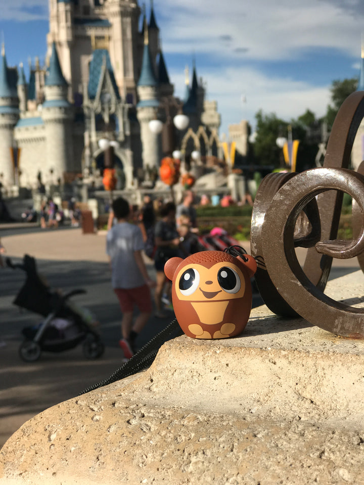 My Audio Pet GoGoBananas Wireless Bluetooth Speaker with True Wireless Stereo Monkey posing at the Disney Cinderella Castle in Disney's Magic Kingdom